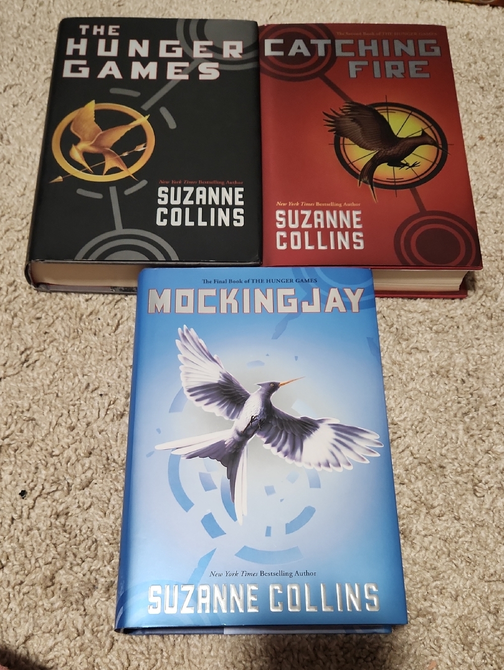 The Hunger Games Trilogy by Suzanne Collins - Black, Red, Blue